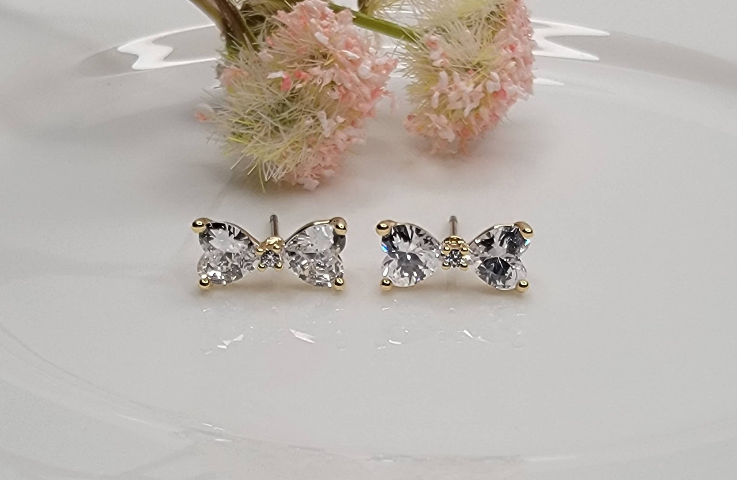 CZ BOW STUD EARRINGS.