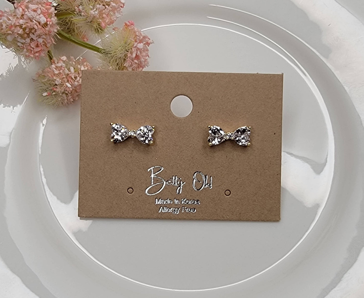 CZ BOW STUD EARRINGS.