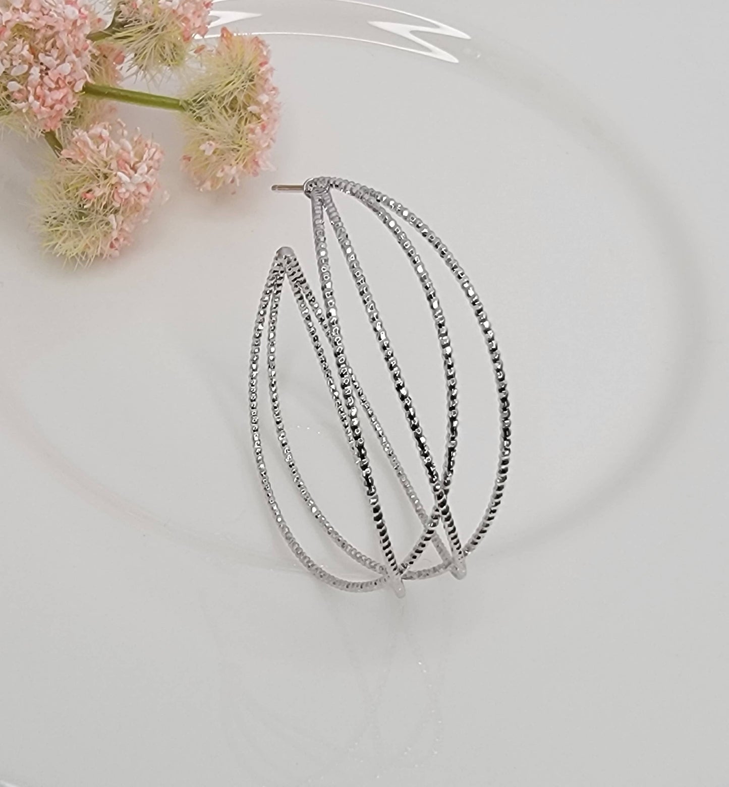 LAZER CUT CRISS CROSS HOOP EARRINGS.