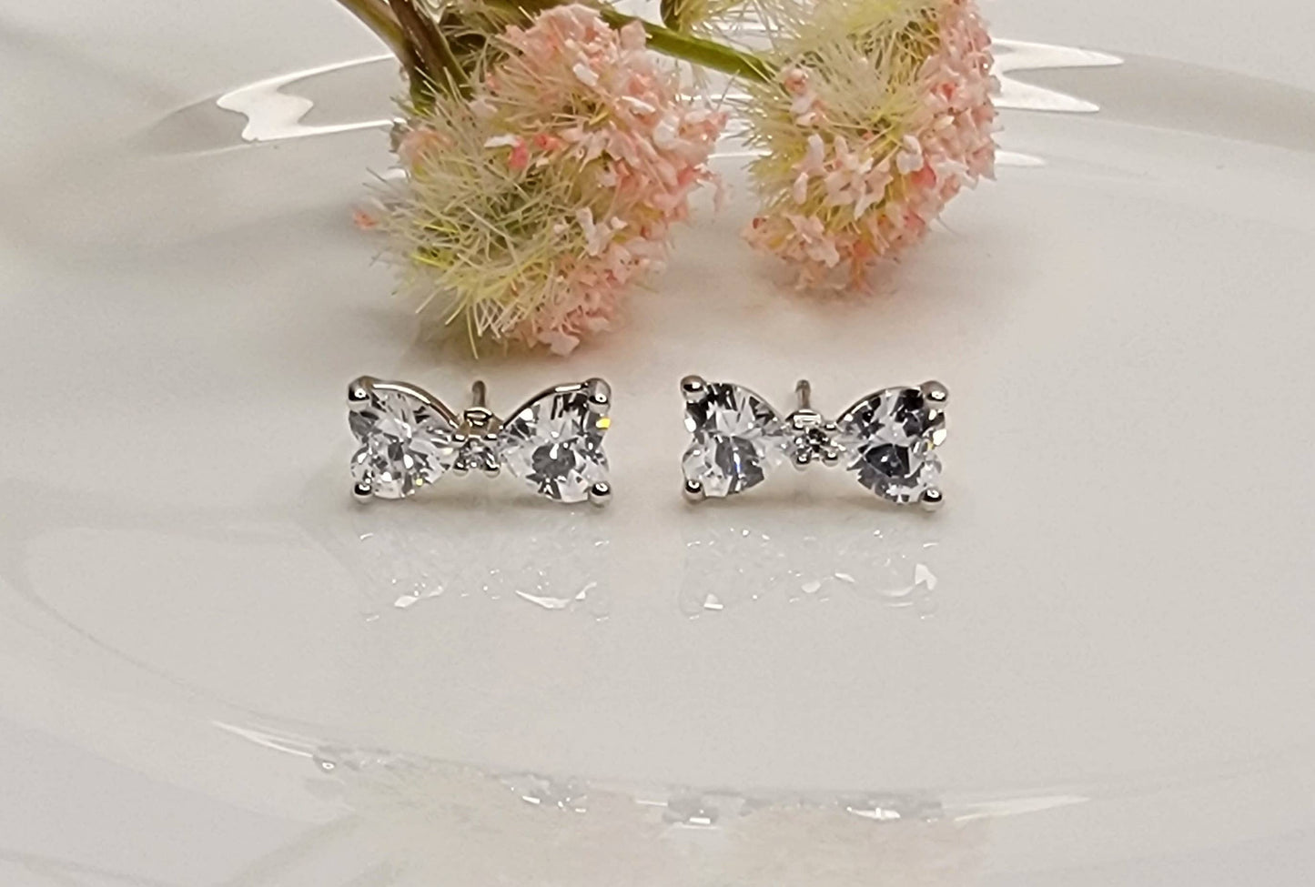 CZ BOW STUD EARRINGS.
