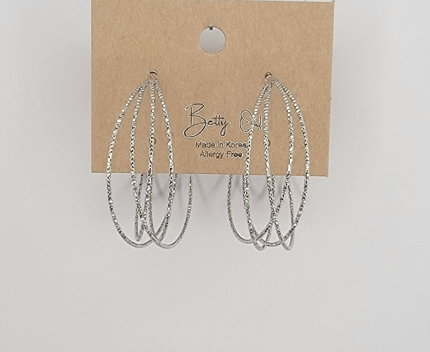 LAZER CUT CRISS CROSS HOOP EARRINGS.