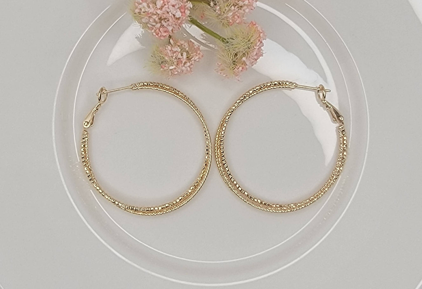 TWISTED WIRE HOOP EARRINGS.