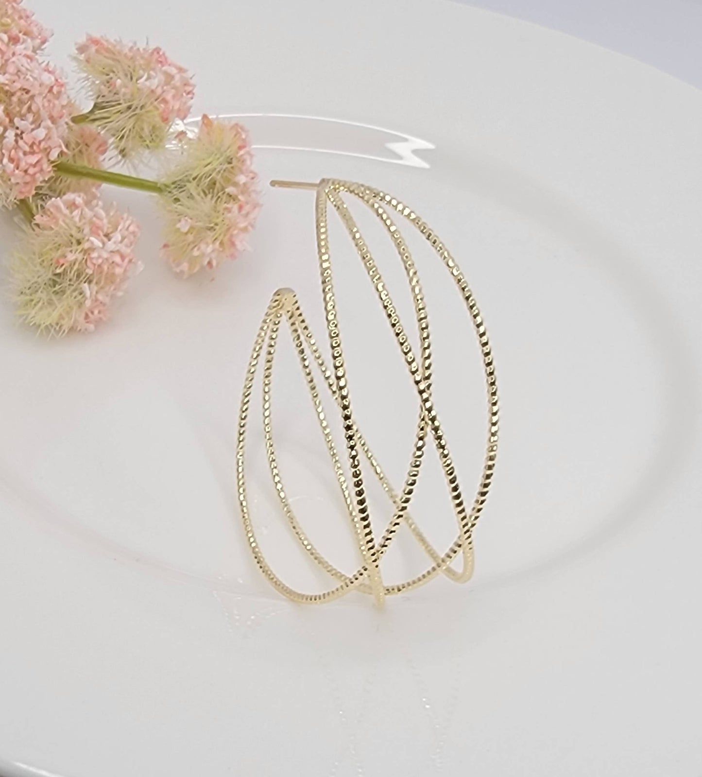 LAZER CUT CRISS CROSS HOOP EARRINGS.