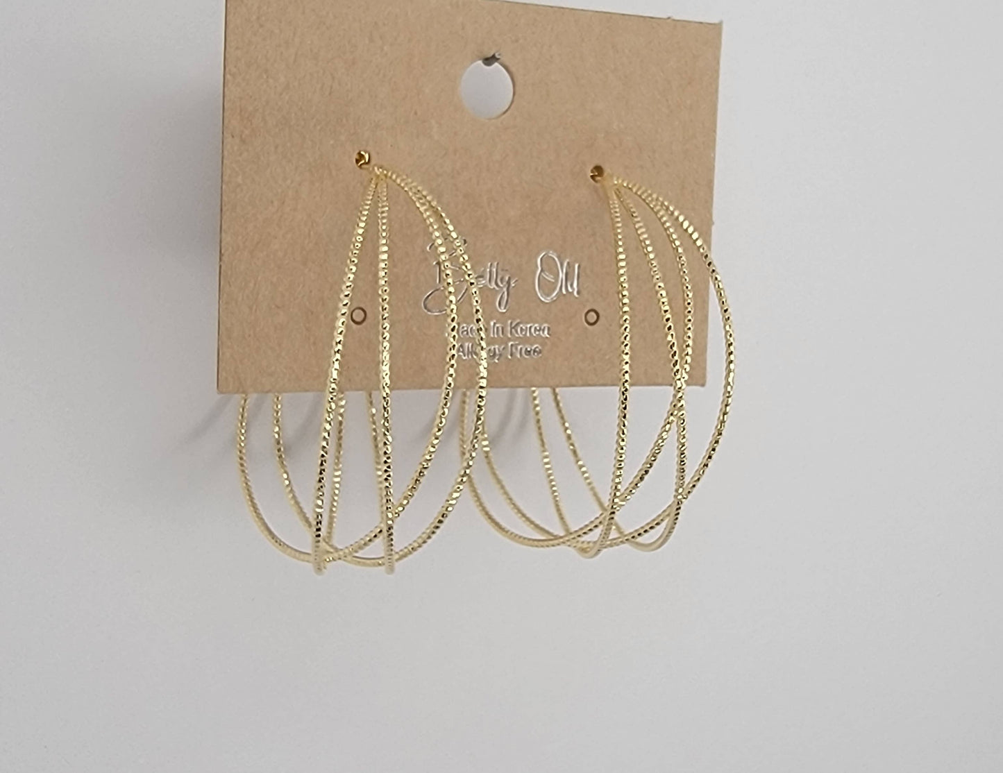 LAZER CUT CRISS CROSS HOOP EARRINGS.