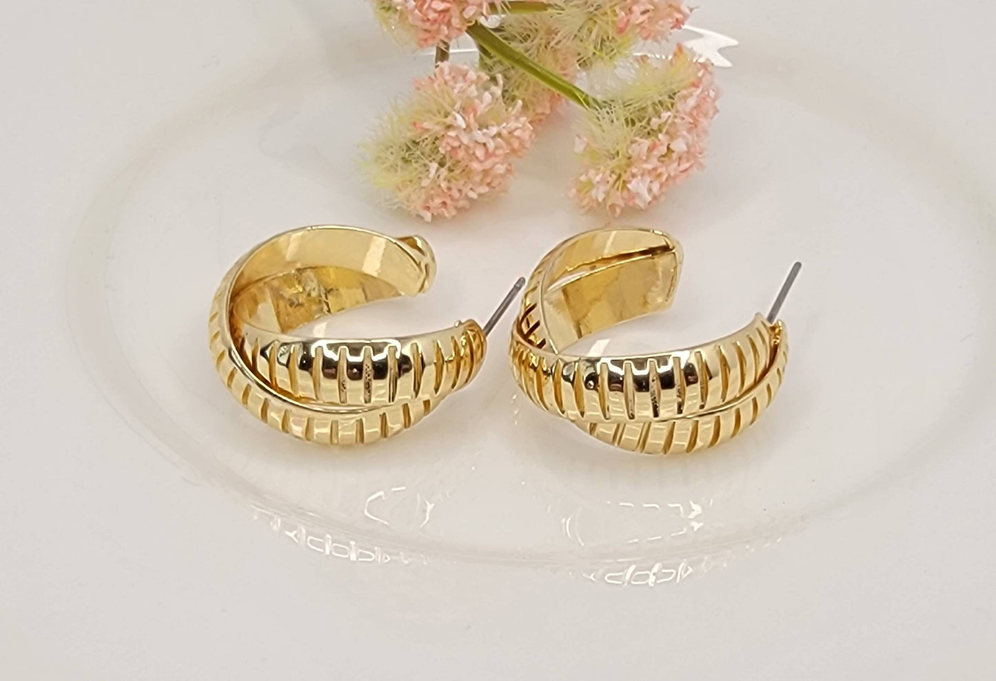 X CROSS HOOP EARRINGS.