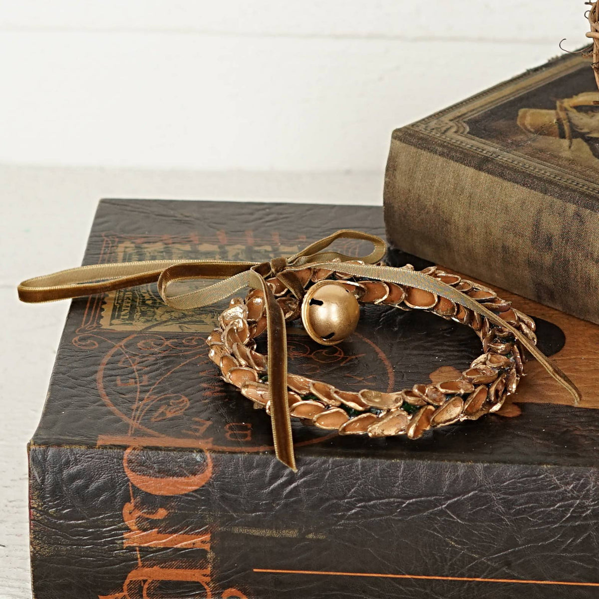 571037- 4.5inD Nut Shell Ring with Gold Bell and Brown ribbo